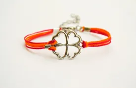 Clover bracelet, orange and pink cord bracelet with a silver shamrock charm, children's size